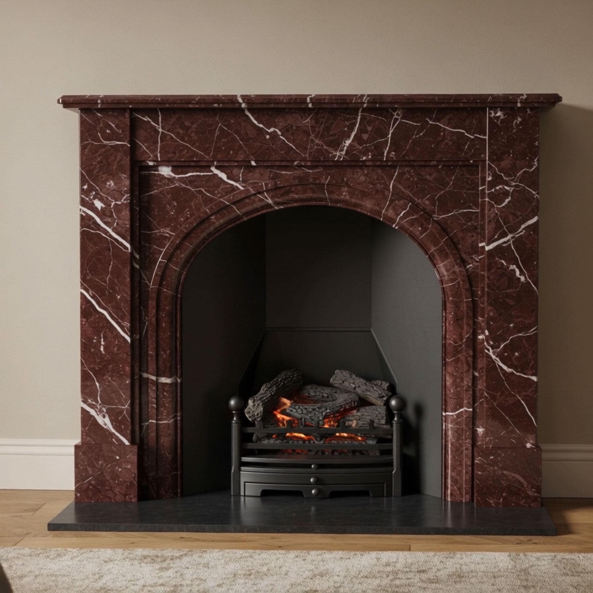 Handcrafted arched fireplace surround in rich cherry red Rosso Levanto marble with white veining