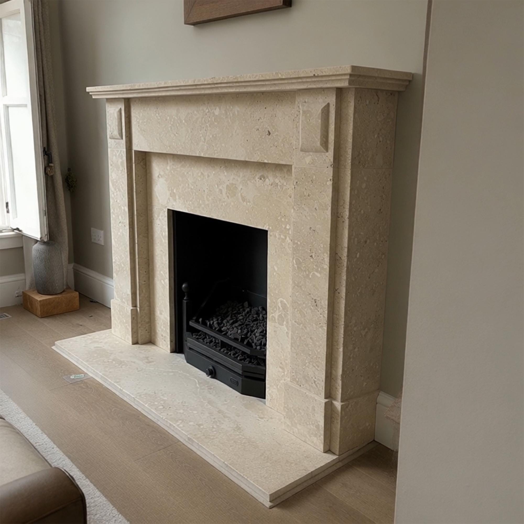 Custom-designed beige marble fireplace showcasing natural stonework and elegant symmetry
