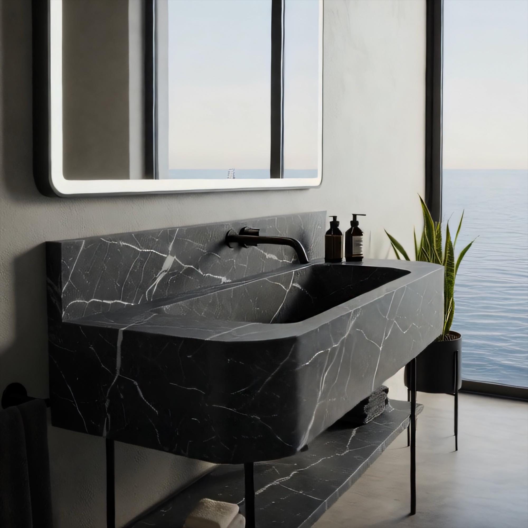 Wall-mounted black marble console sink with integrated shelf and streamlined design