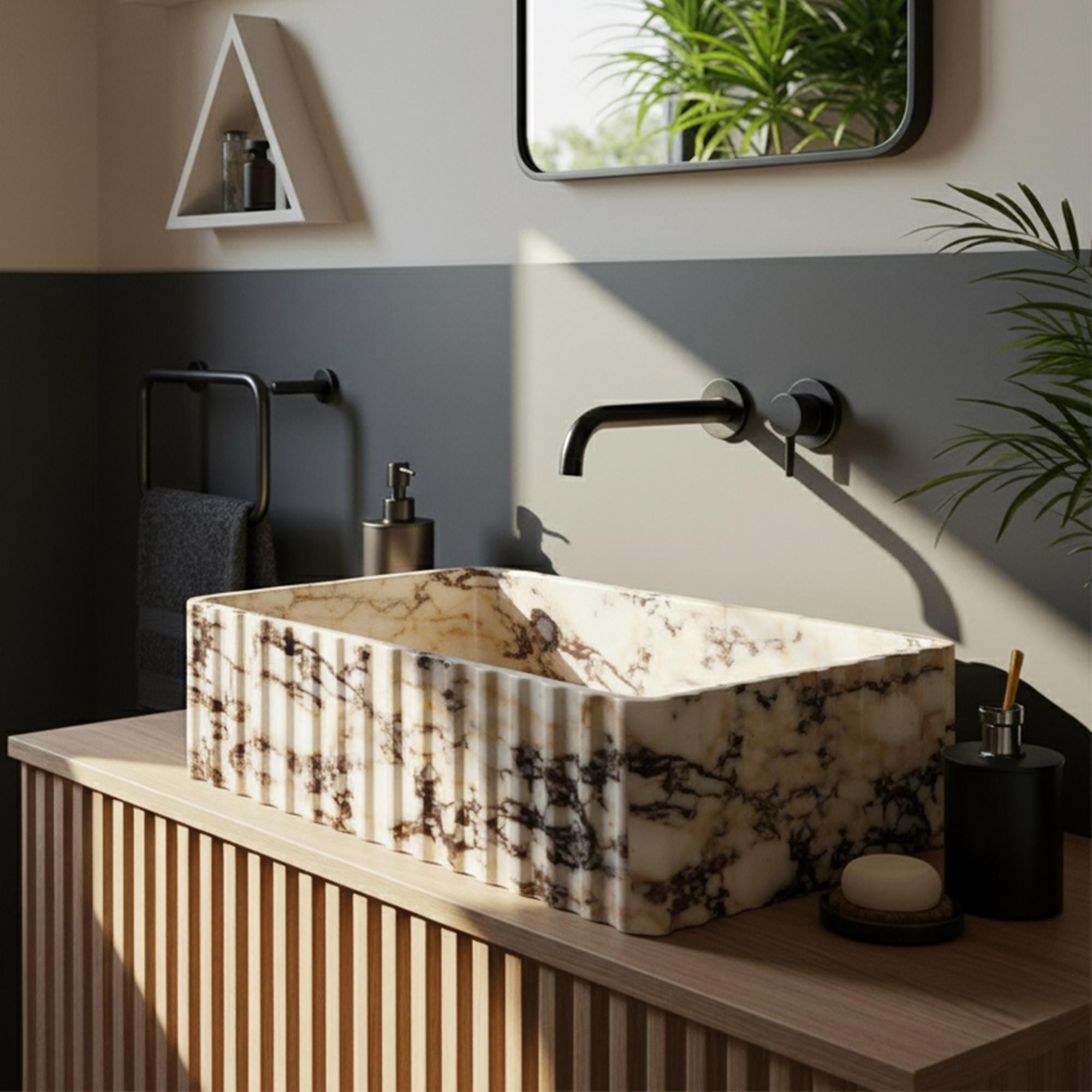 Hand-carved Calacatta Amber Viola marble vessel sink with fluted exterior on slatted wood vanity