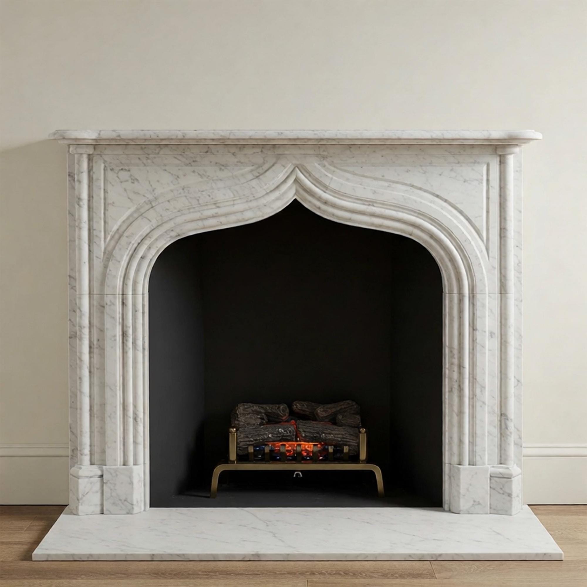 Custom handcrafted fireplace mantel in white marble with a graceful French Gothic arch