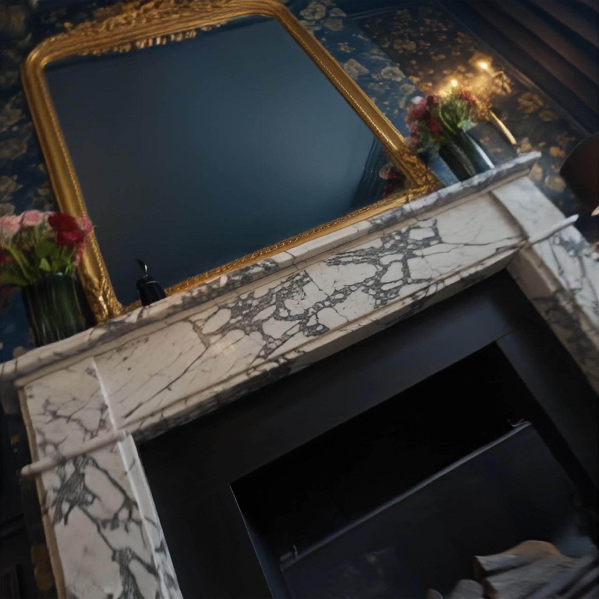Designer fireplace installation with Calacatta Viola marble, gold frame mirror, and luxurious interior styling