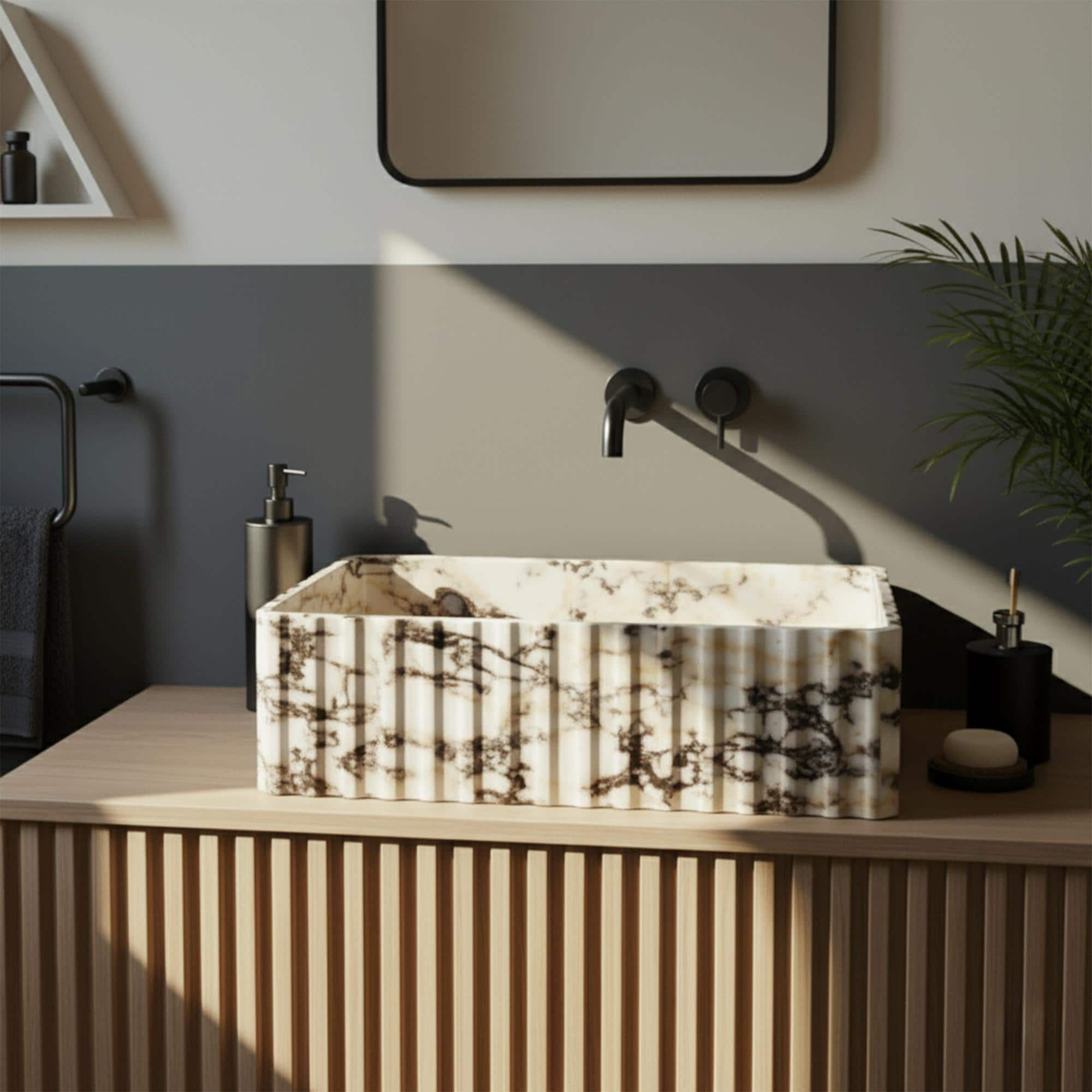 Fluted stone vessel sink in Calacatta Amber Viola marble with dark veining and modern black wall-mounted faucet