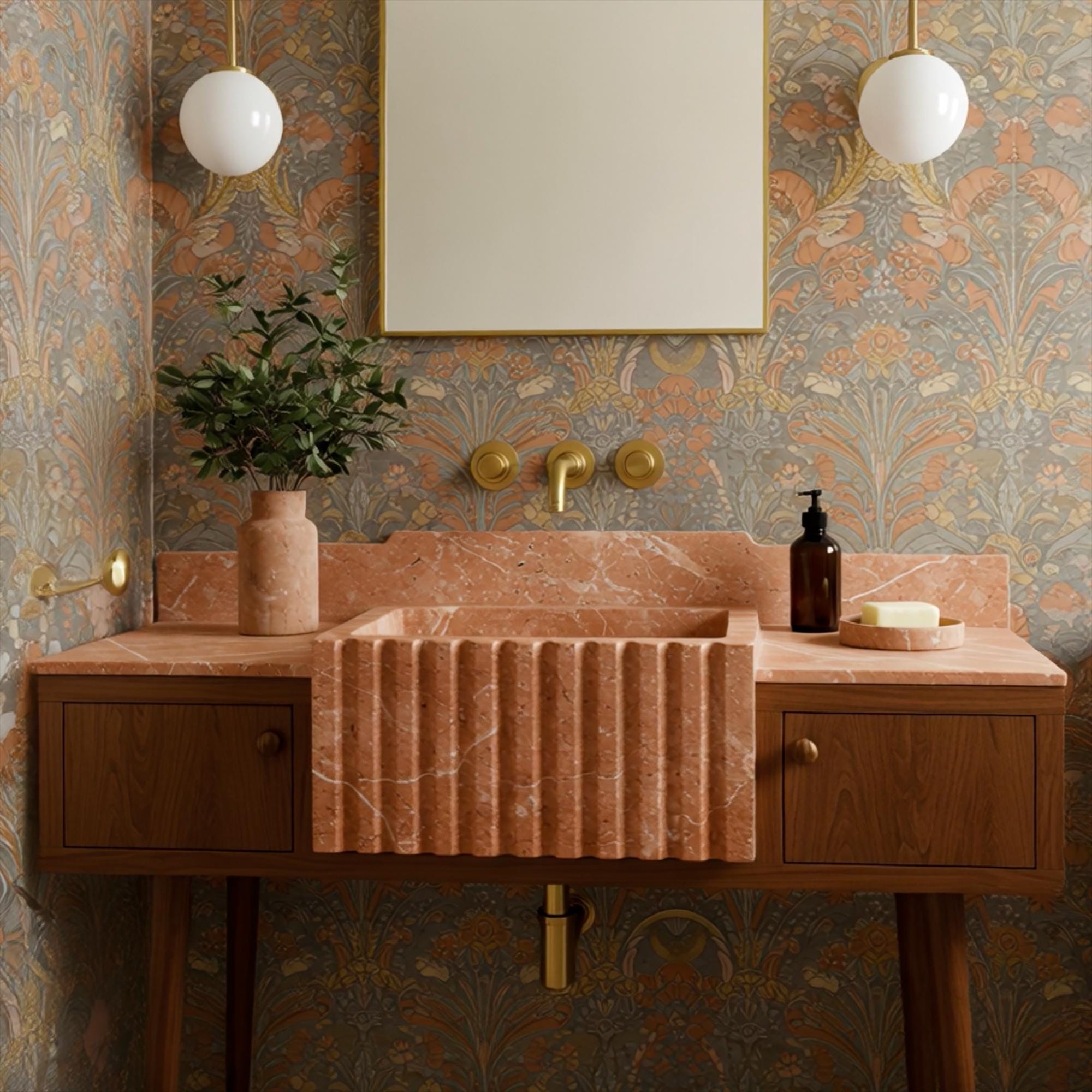 Pink marble apron sink with vertical fluting detail, vintage-inspired wallpaper and warm wood elements