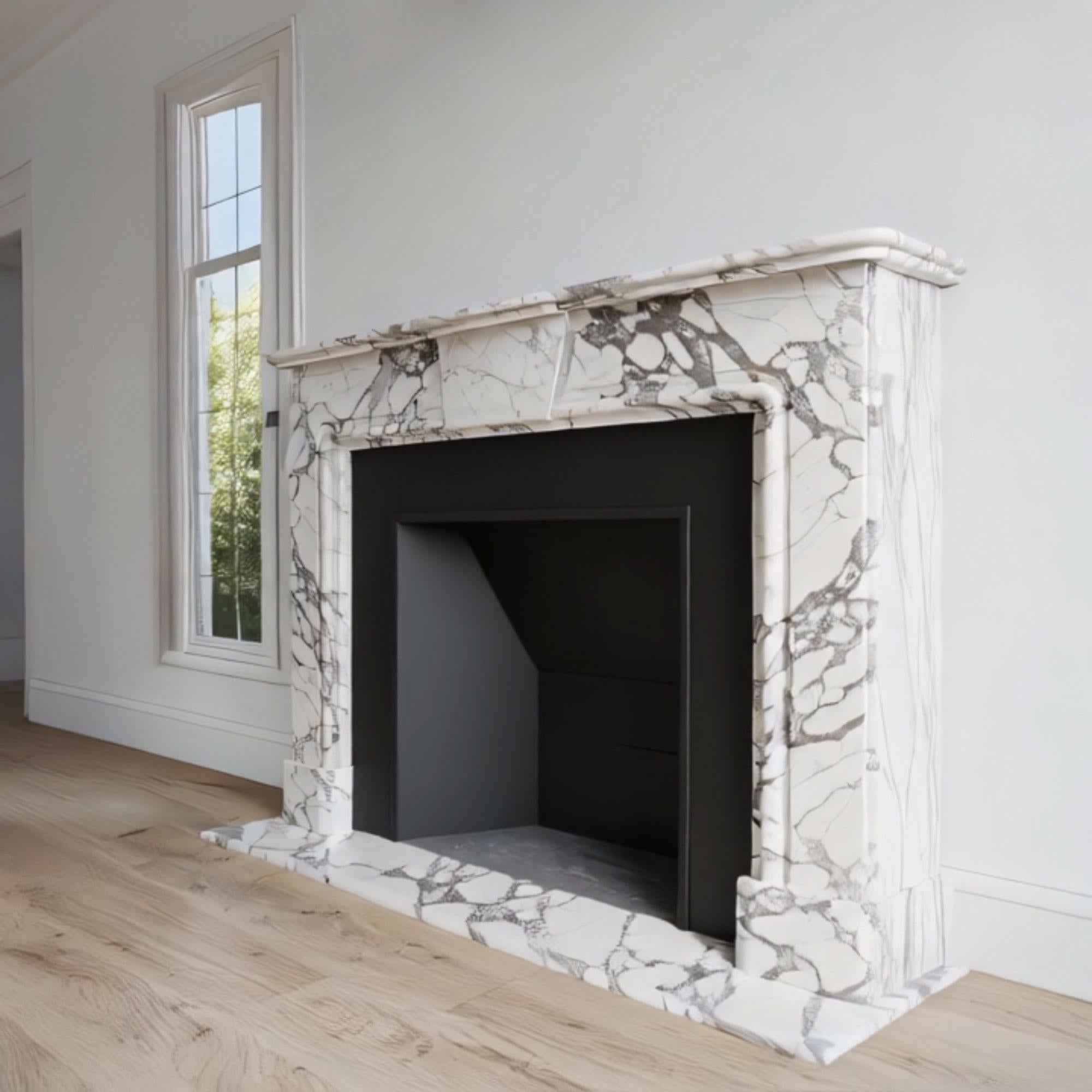 Elegant white marble fireplace featuring dark veining and a keystone element, carved from premium Calacatta stone