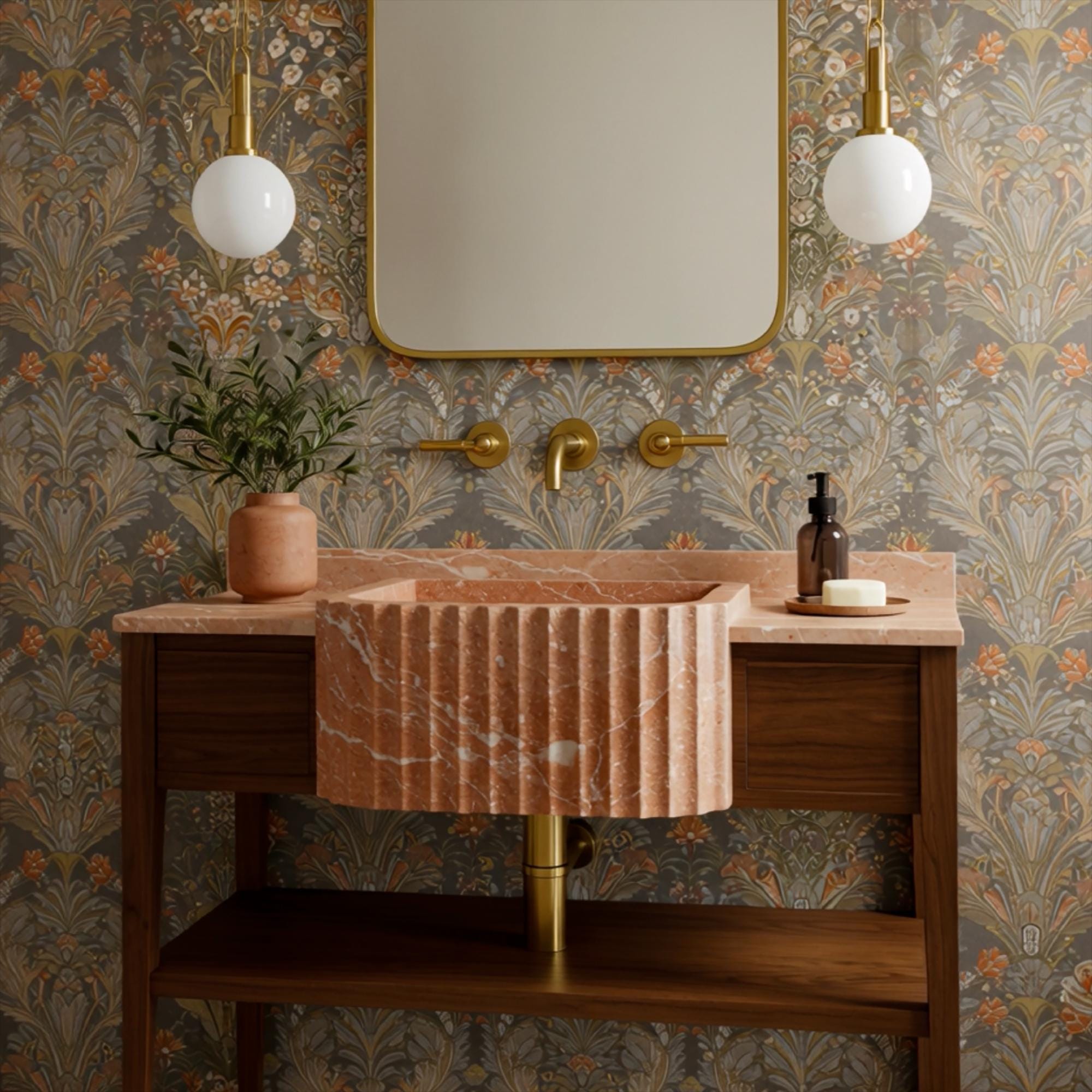 Wall-mounted fluted marble apron sink in pink tones with decorative wood console and brass fittings