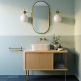 Hand-carved natural stone vessel sink on modern wood vanity with brass fixtures