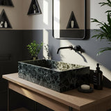 Hand-carved Rosso Levanto cherry marble vessel sink paired with a minimalist wood vanity in a modern bathroom
