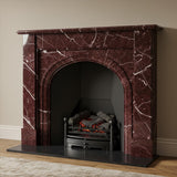 Elegant Rosso Levanto cherry marble fireplace mantel featuring a rounded arch and bold veining