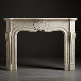 Ornate cream marble fireplace mantel with shell motif and baroque-style handcrafted stonework