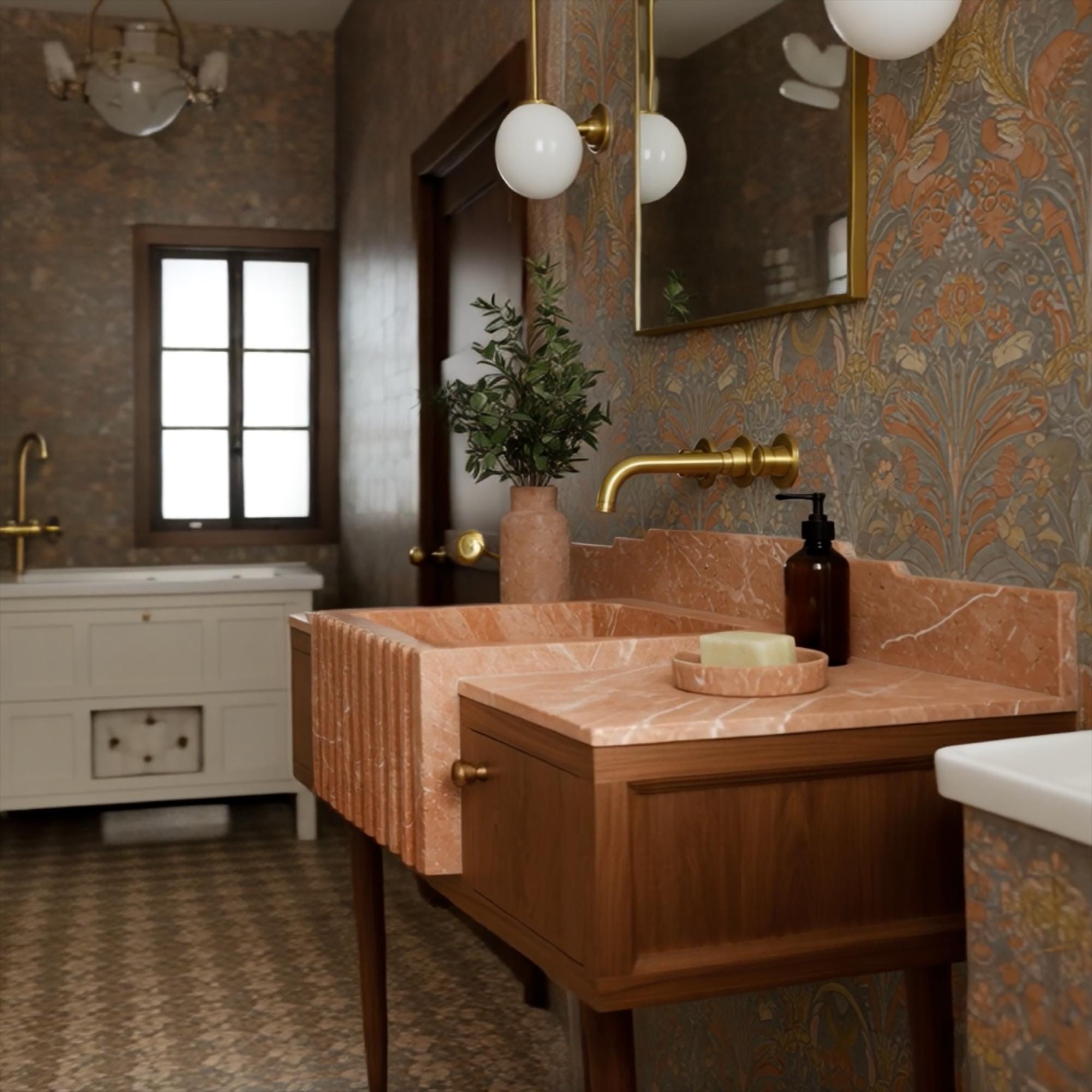 Pink fluted marble sink on retro wooden vanity with floral wallpaper and brass faucet accents